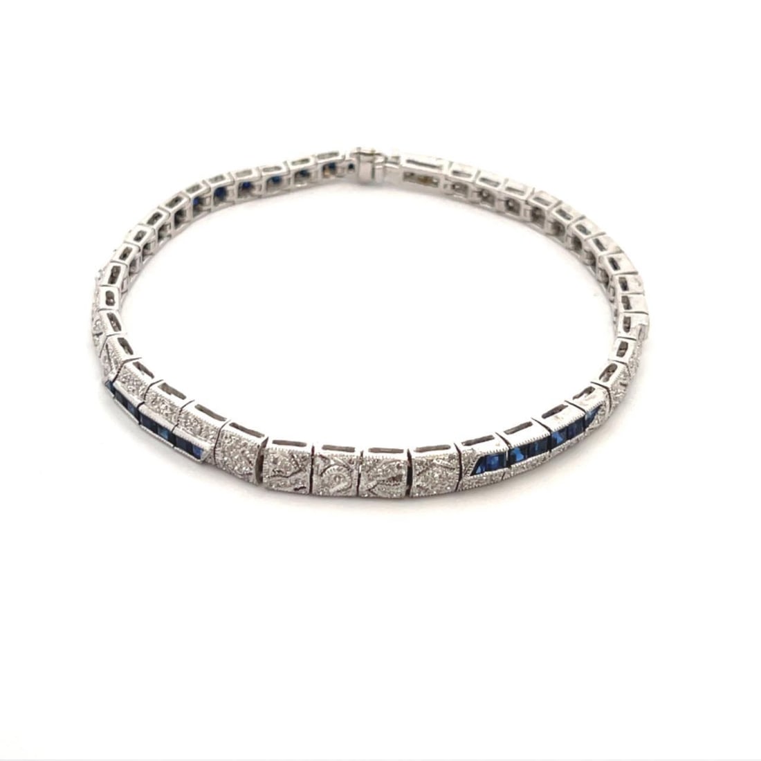 Elegant Art Deco 18k White Gold Diamond Bracelet with Blue Stones: Elegant Art Deco 18k White Gold Diamond Bracelet with Blue Stones This exquisite Art Deco style bracelet is expertly crafted from 18k white gold, featuring a series of elegant box shape section links.