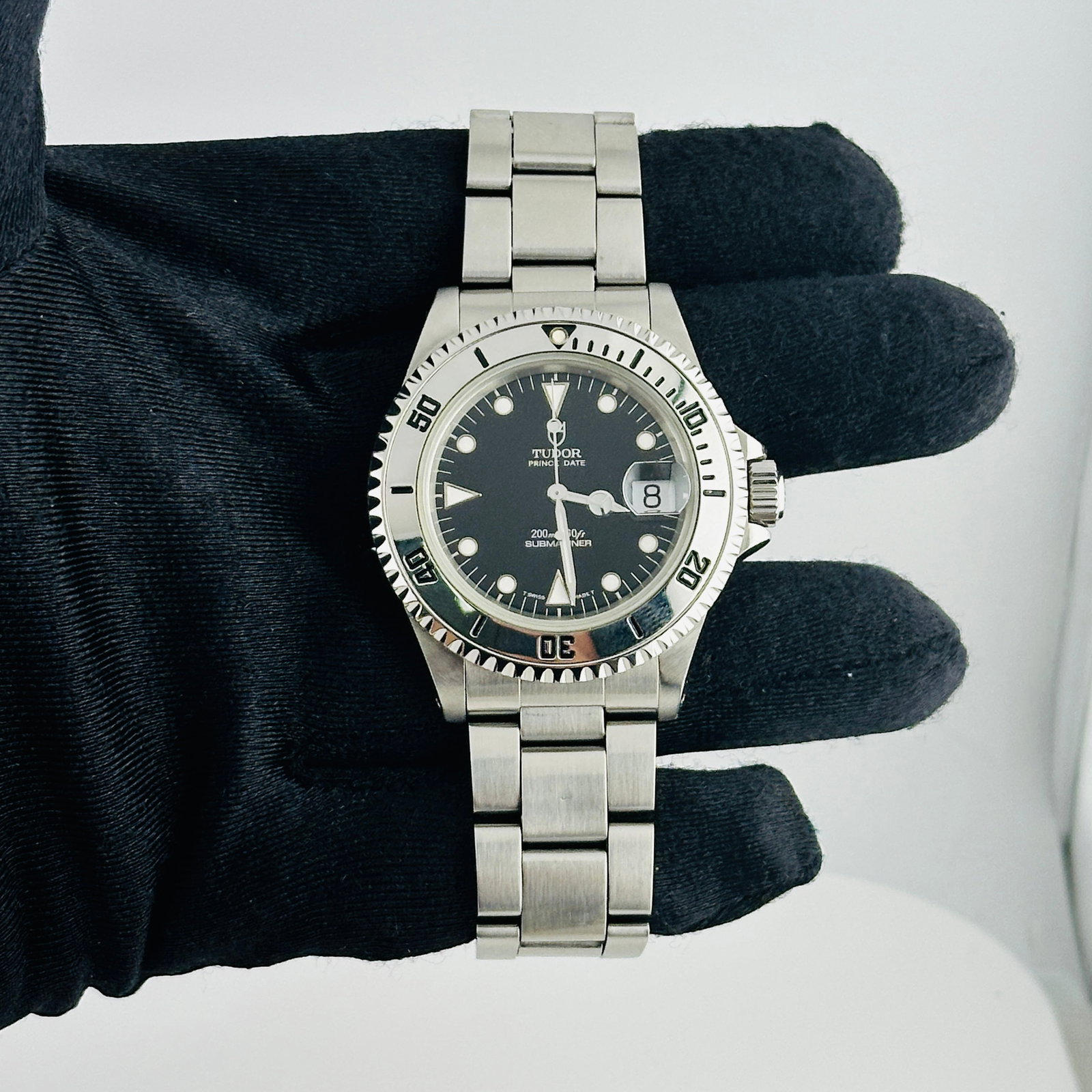 Tudor Submariner Prince Date Black Dial Folded Oyster Bracelet Ref 79190: Tudor Submariner Prince Date Black Dial Folded Oyster Bracelet Ref 79190 This Tudor Submariner Prince Date features a black dial and a rotating bezel, paired with a folded Oyster bracelet. The watch i