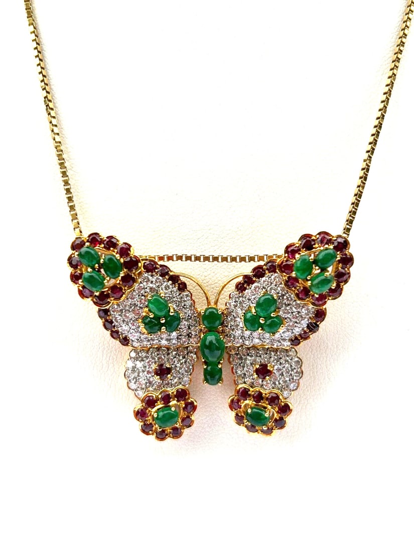 French 18K Gold Butterfly Brooch with Diamonds Rubies Emeralds: French 18K Gold Butterfly Brooch with Diamonds Rubies Emeralds This exquisite French butterfly brooch is crafted from 18K yellow and white gold and showcases a stunning array of gemstones. It features
