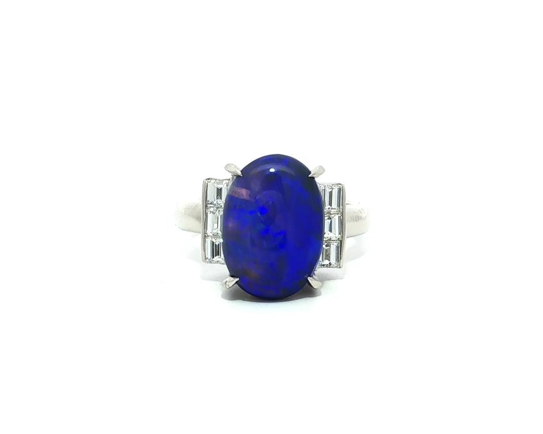 Platinum GIA Certified 5.48ct Blue Black Opal Ring with Baguette Diamonds: Platinum GIA Certified 5.48ct Blue Black Opal Ring with Baguette Diamonds This exquisite cocktail ring showcases a stunning 5.48 carat total weight featuring a vibrant natural blue-black opal and eleg