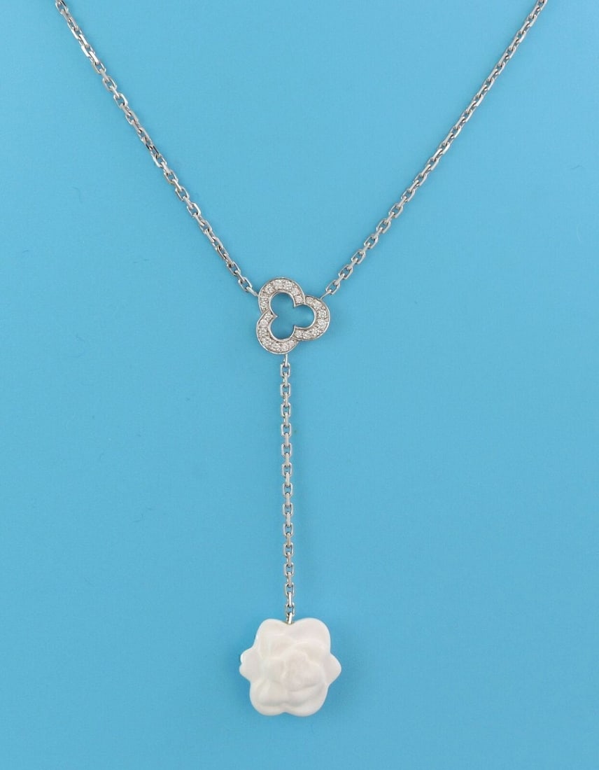 Chanel Camellia 18k White Gold Lariat Necklace with White Agate Diamonds: Chanel Camellia 18k White Gold Lariat Necklace with White Agate Diamonds This Chanel Camellia lariat necklace is crafted from 18k white gold and features three camellia motifs adorned with white agate