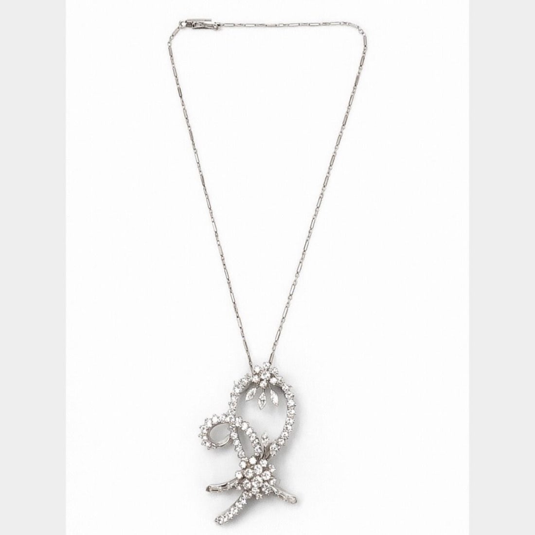 Diamond Platinum Art Deco Pendant Brooch on 14K White Gold Necklace: Diamond Platinum Art Deco Pendant Brooch on 14K White Gold Necklace This Art Deco piece functions as both a platinum diamond brooch and a pendant, suspended on a 14K white gold chain. The brooch/penda