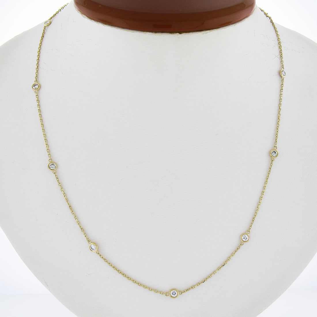14k Yellow Gold 0.71ctw Bezel Diamond Station Necklace 18" Cable Link: 14k Yellow Gold 0.71ctw Bezel Diamond Station Necklace 18" Cable Link This exquisite 14k Yellow Gold necklace features a stunning 0.71ctw of natural diamonds arranged in a bezel setting. The necklace 