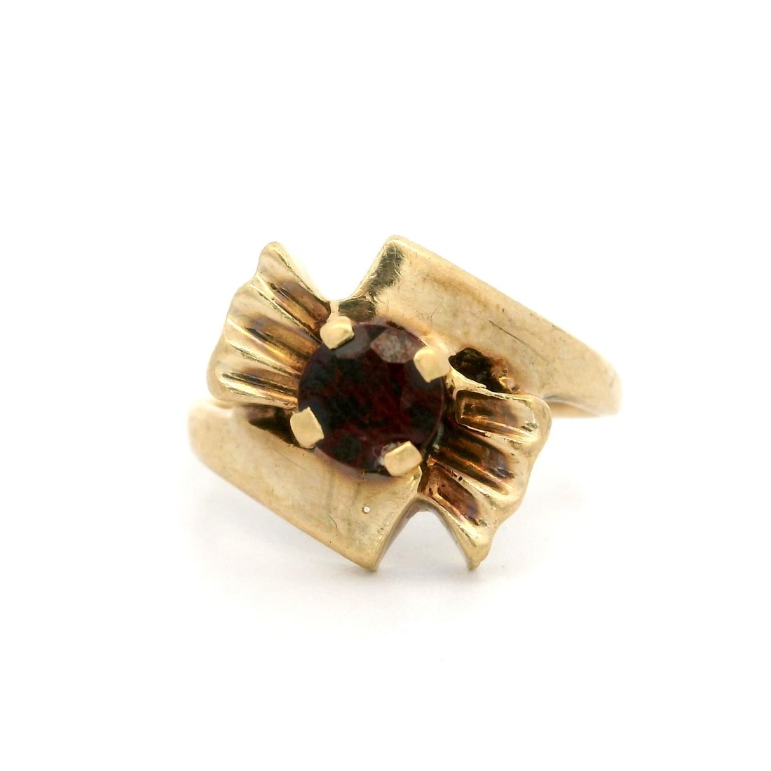 Vintage 10K Yellow Gold Garnet Bypass Bow Ring: Vintage 10K Yellow Gold Garnet Bypass Bow Ring This exquisite vintage retro ring features a beautiful 4.9mm round genuine garnet, prong set to showcase its deep red color. Crafted from 10k yellow gold