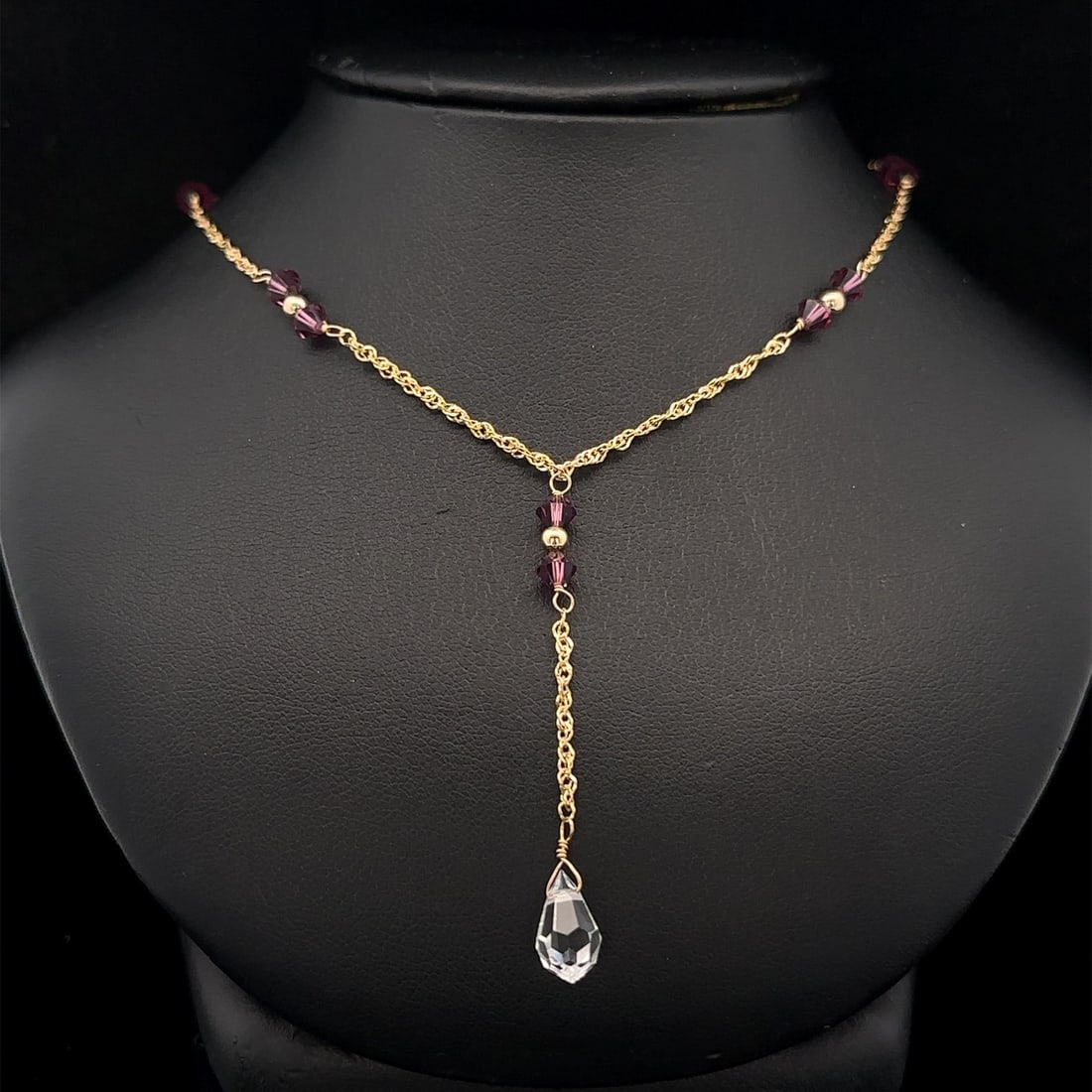 14k Yellow Gold Dangle Drop Necklace with Purple and Clear Gemstones: 14k Yellow Gold Dangle Drop Necklace with Purple and Clear Gemstones This exquisite necklace features a stunning arrangement of natural genuine gemstones, including 10 purple round faceted gemstones a