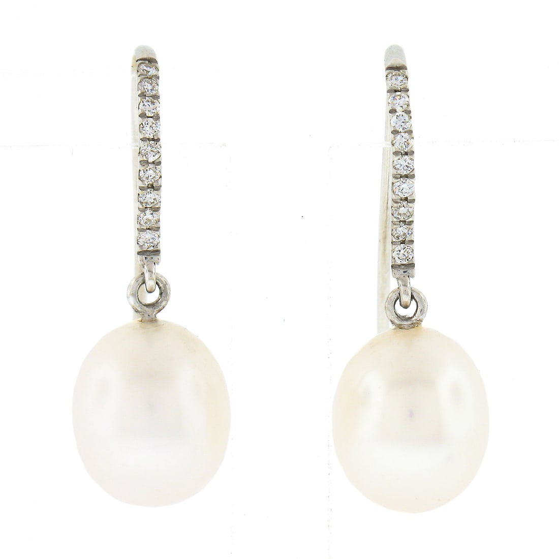 Elegant 14k White Gold Pave Diamond Pearl Drop Earrings: Elegant 14k White Gold Pave Diamond Pearl Drop Earrings Elevate your accessory collection with these exquisite drop earrings, crafted from solid 14k white gold. Featuring two oval-shaped cultured pear