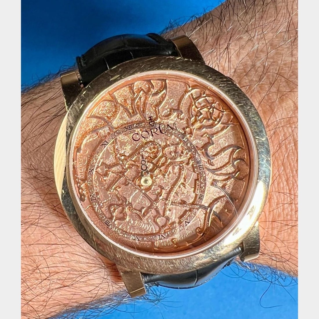 Corum 18K Yellow Gold Automatic 42mm Watch: Corum 18K Yellow Gold Automatic 42mm Watch This Corum watch features a 42mm case crafted from 18K yellow gold, paired with an original Corum leather strap and a deployant clasp for secure and comforta