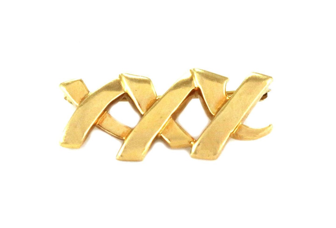 Tiffany & Co. Paloma Picasso 18k Gold Triple X Brooch 1989: Tiffany & Co. Paloma Picasso 18k Gold Triple X Brooch 1989 This exquisite vintage brooch from Tiffany & Co. showcases a unique triple X design, expertly crafted from 18k yellow gold. The piece feature
