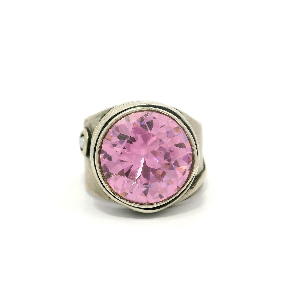 Handmade Sterling Silver Pink CZ Large Solitaire Ring: Handmade Sterling Silver Pink CZ Large Solitaire Ring This stunning handmade ring features a large pink cubic zirconia stone in a round brilliant cut, bezel set for a secure fit. The vibrant pink colo