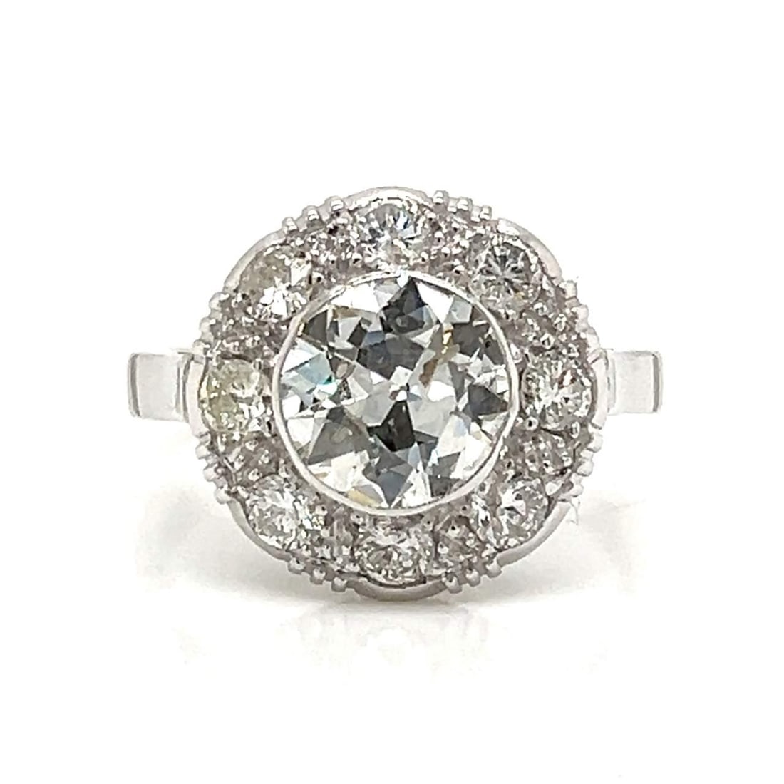 Art Deco 18K White Gold Diamond Ring 1.80 Ct with 8 Accent Diamonds: Art Deco 18K White Gold Diamond Ring 1.80 Ct with 8 Accent Diamonds This stunning Art Deco ring features a radiant 1.80 Ct. diamond, characterized by a J color and SI2 clarity, beautifully crafted in 