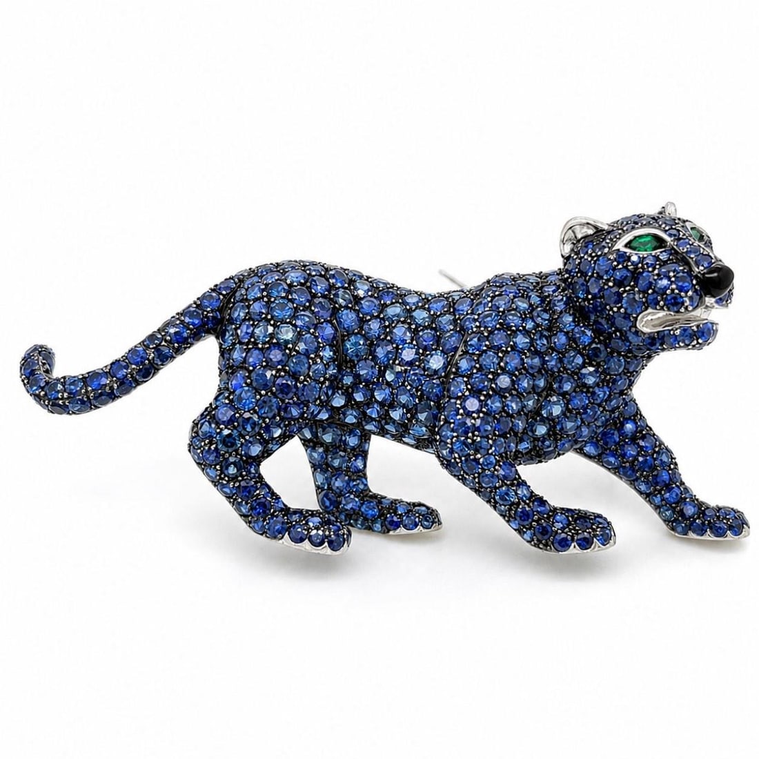 Panther Brooch 18K White Gold with Sapphire and Emerald Eyes: Panther Brooch 18K White Gold with Sapphire and Emerald Eyes This elegant brooch is crafted in 18K white gold and designed in the shape of a panther. The piece features approximately 10.00 carats of s