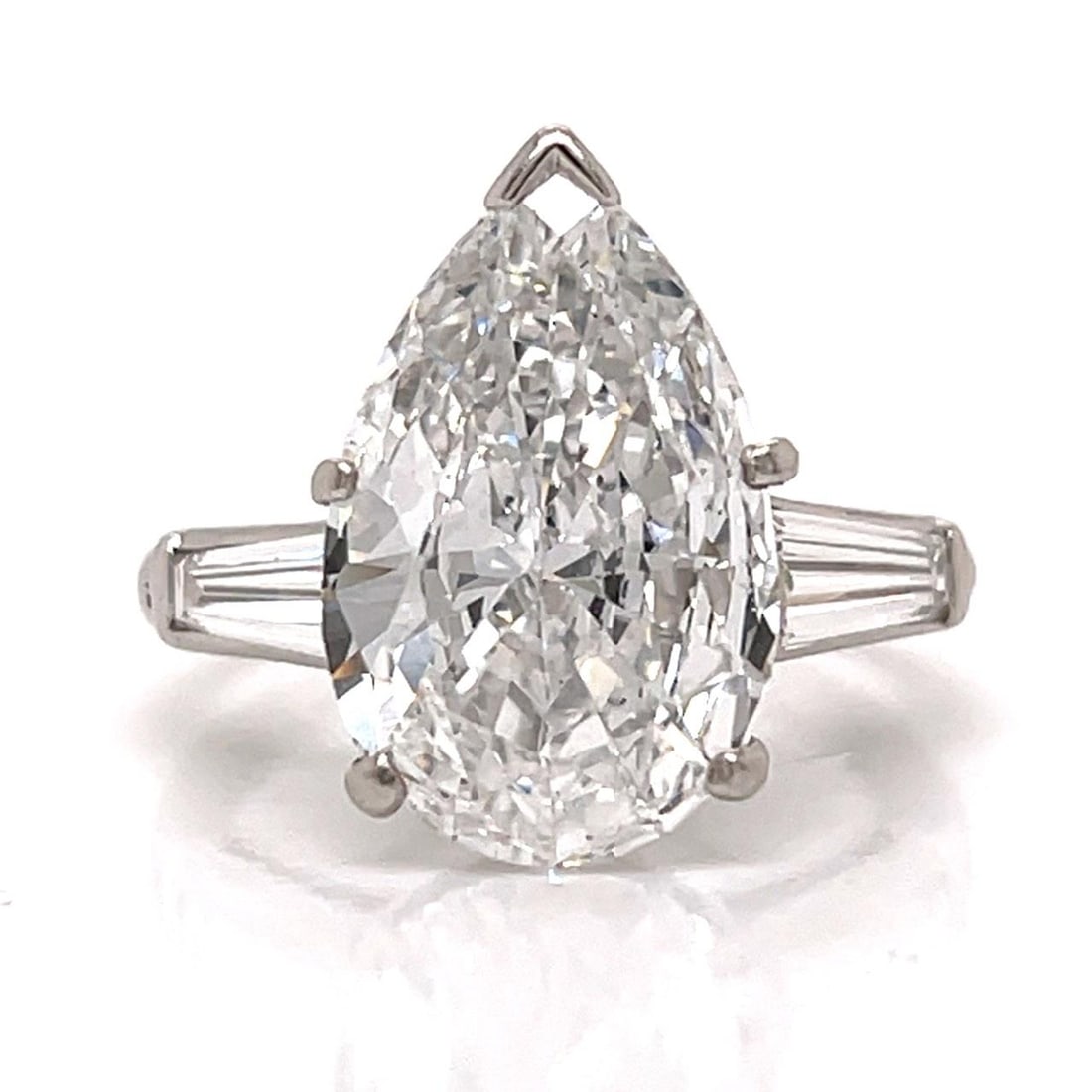 Platinum Art Deco Ring with 5.07 Ct Pear Diamond GIA Certified: Platinum Art Deco Ring with 5.07 Ct Pear Diamond GIA Certified This Art Deco platinum ring features a GIA certified 5.07 carat pear-shaped diamond with D color and SI1 clarity, accented by two baguett