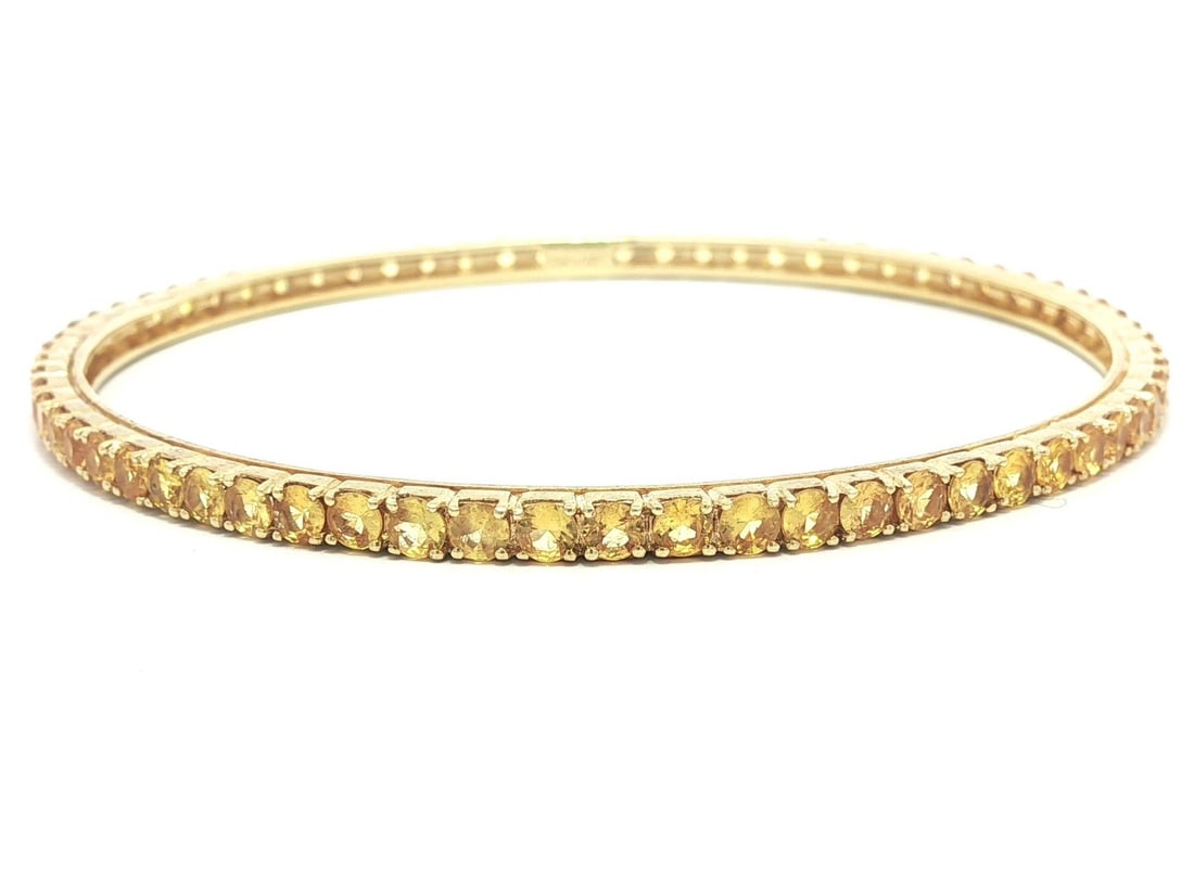 18K Yellow Gold Sapphire Eternity Slip On Bangle Bracelet: 18K Yellow Gold Sapphire Eternity Slip On Bangle Bracelet This elegant slip-on bangle bracelet features an eternity tennis style, crafted from solid 18k yellow gold. The bracelet is adorned with numer