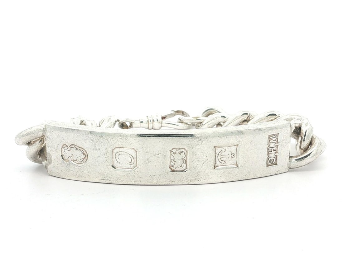Sterling Silver Curb Link ID Bracelet with Dog Clip Clasp Vintage English: Sterling Silver Curb Link ID Bracelet with Dog Clip Clasp Vintage English This vintage English ID bracelet features a large sterling silver ID bar on an 11.2mm wide curb link chain, secured with a dog