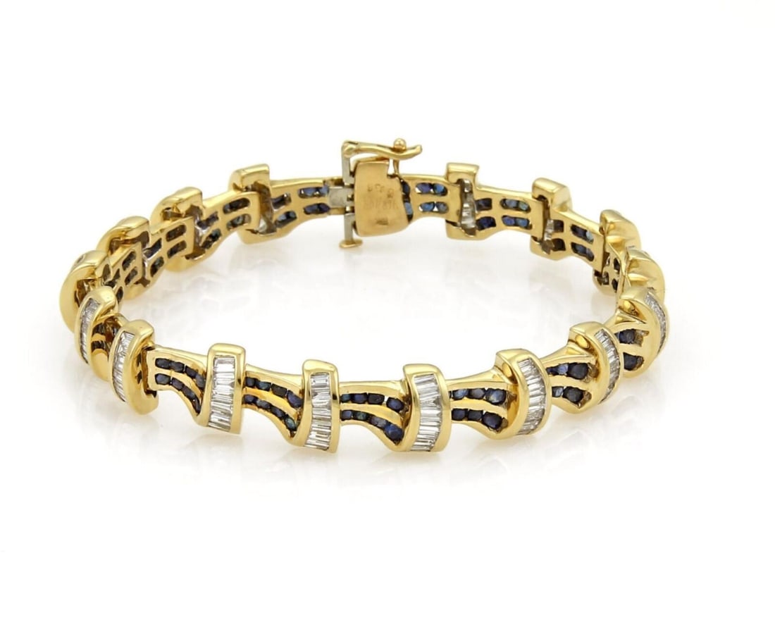 Vintage 18k Yellow Gold Tennis Bracelet with Diamonds and Sapphires: Vintage 18k Yellow Gold Tennis Bracelet with Diamonds and Sapphires This vintage tennis bracelet features a classic line design crafted in 18k yellow gold. The piece is set with alternating brilliant 