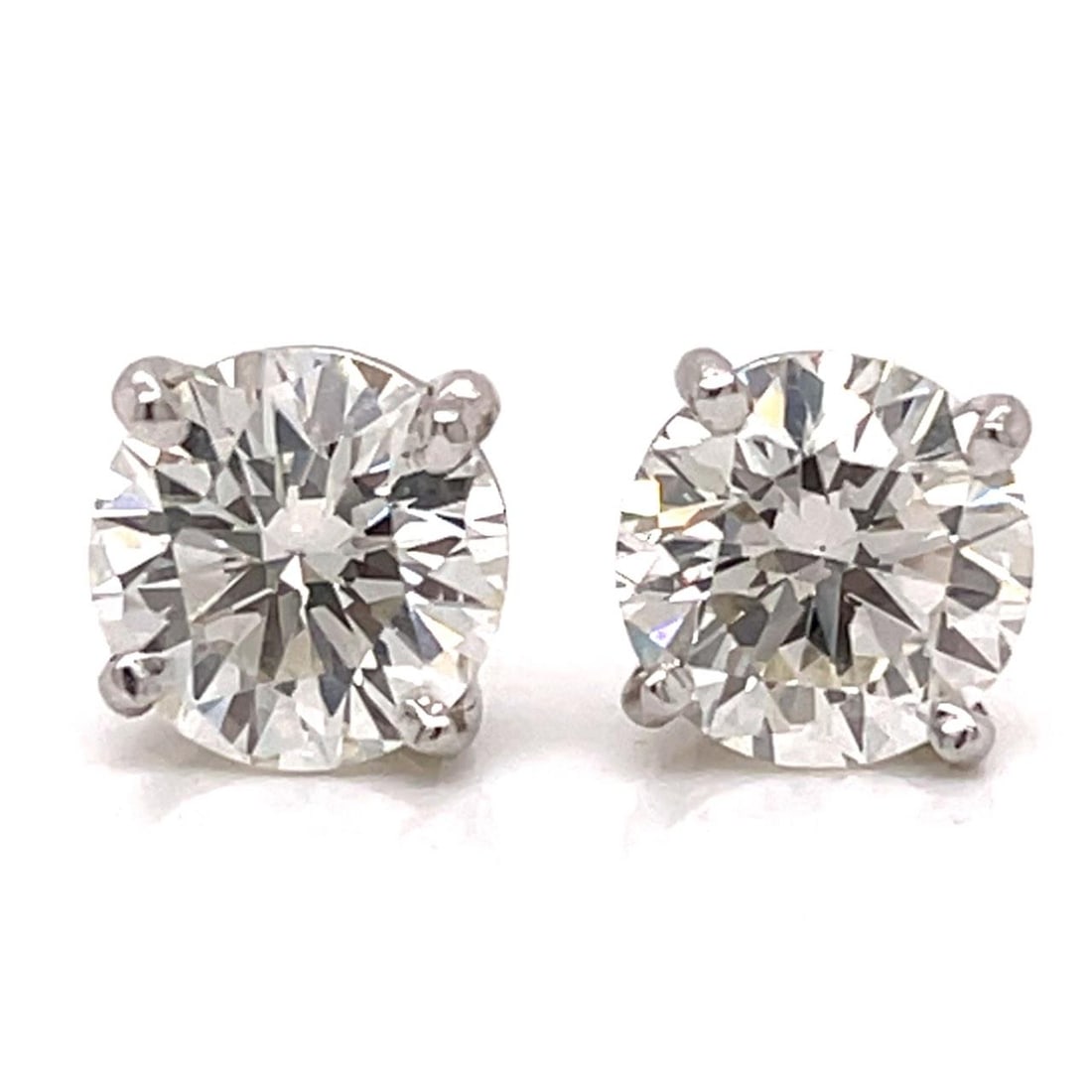 GIA Certified Platinum Stud Earrings with 2.29 Ct Diamond Pair: GIA Certified Platinum Stud Earrings with 2.29 Ct Diamond Pair This pair of platinum diamond stud earrings features two GIA certified round diamonds. One earring is set with a 2.12 carat diamond of J 