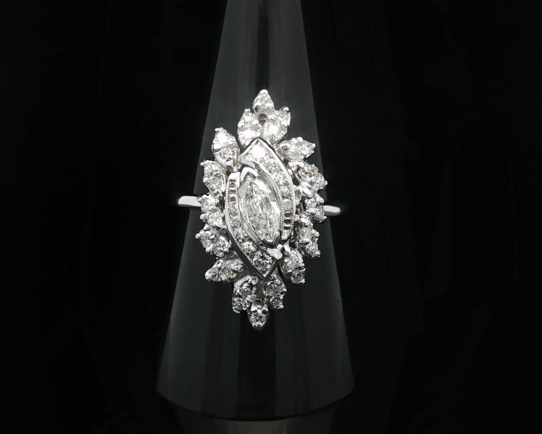 Vintage White Gold Marquise Diamond Cocktail Ring 0.70ctw: Vintage White Gold Marquise Diamond Cocktail Ring 0.70ctw This exquisite vintage cocktail ring showcases a stunning arrangement of diamonds set in solid white gold. The centerpiece features a natural 