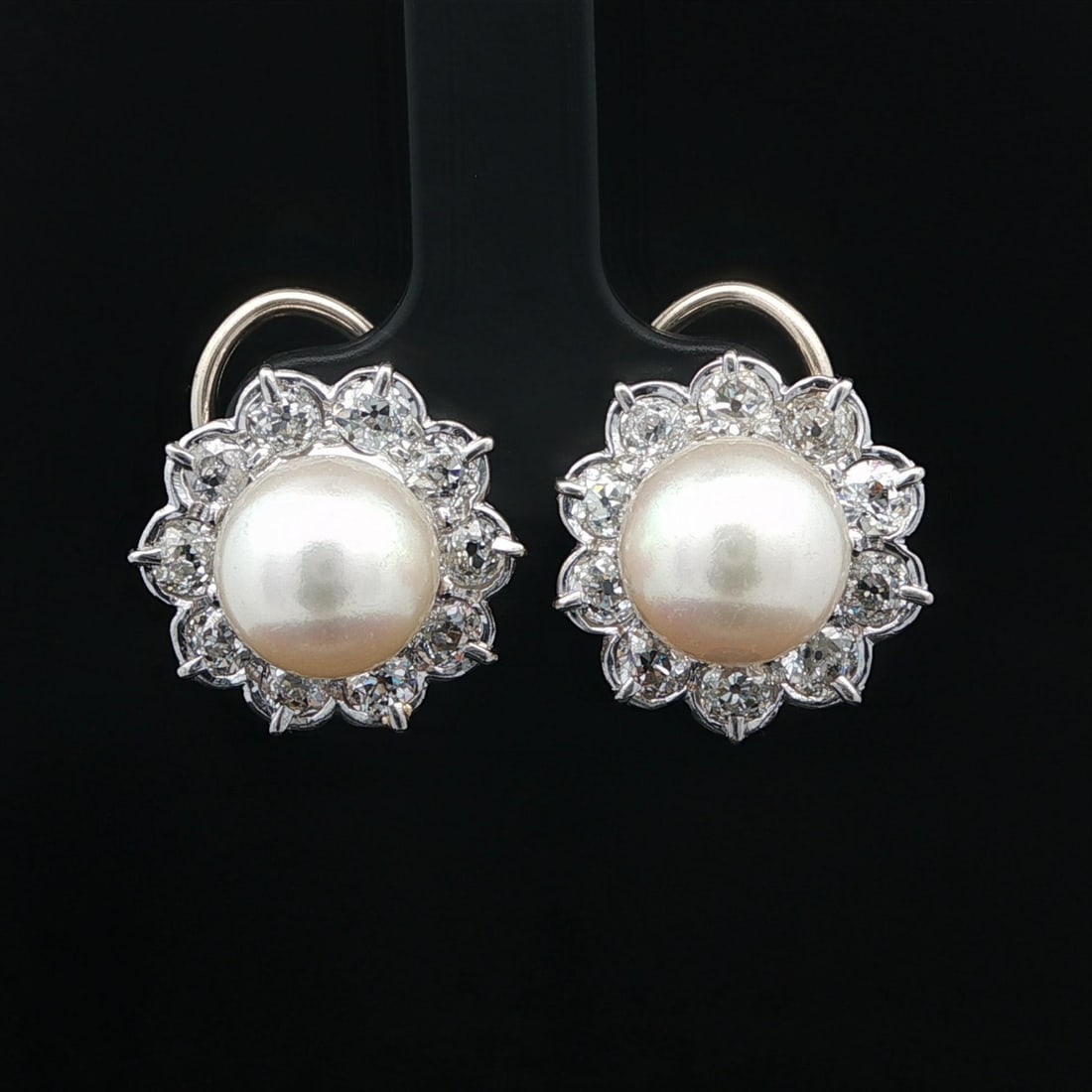 Antique Platinum 14k Gold Diamond Halo Earrings with 9.2mm Pearls: Antique Platinum 14k Gold Diamond Halo Earrings with 9.2mm Pearls These exquisite antique earrings feature a stunning design with a halo of old mine cut diamonds surrounding two genuine cultured pearl