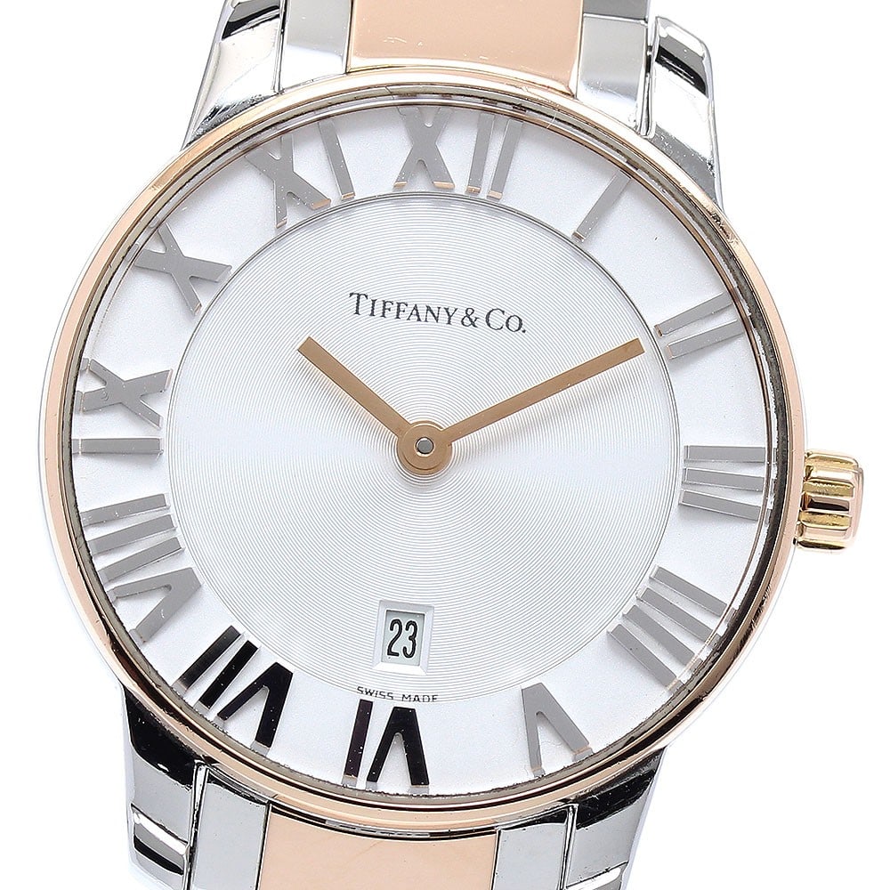 Tiffany Atlas Dome quartz date ladies wristwatch: Tiffany Atlas Dome quartz date ladies wristwatch This pre-owned Tiffany & Co. Atlas Dome Date Quartz ladies wristwatch features a stainless steel and rose gold case and bracelet, complemented by a sil