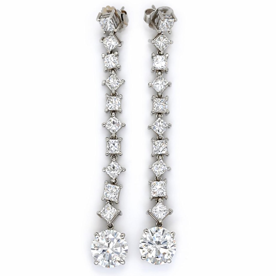 Earrings in Platinum with 20.84 Carats of Round and Princess Diamonds: Earrings in Platinum with 20.84 Carats of Round and Princess Diamonds These platinum earrings feature a total diamond weight of 20.84 carats. Each earring is set with a round diamond, weighing 5.20 an