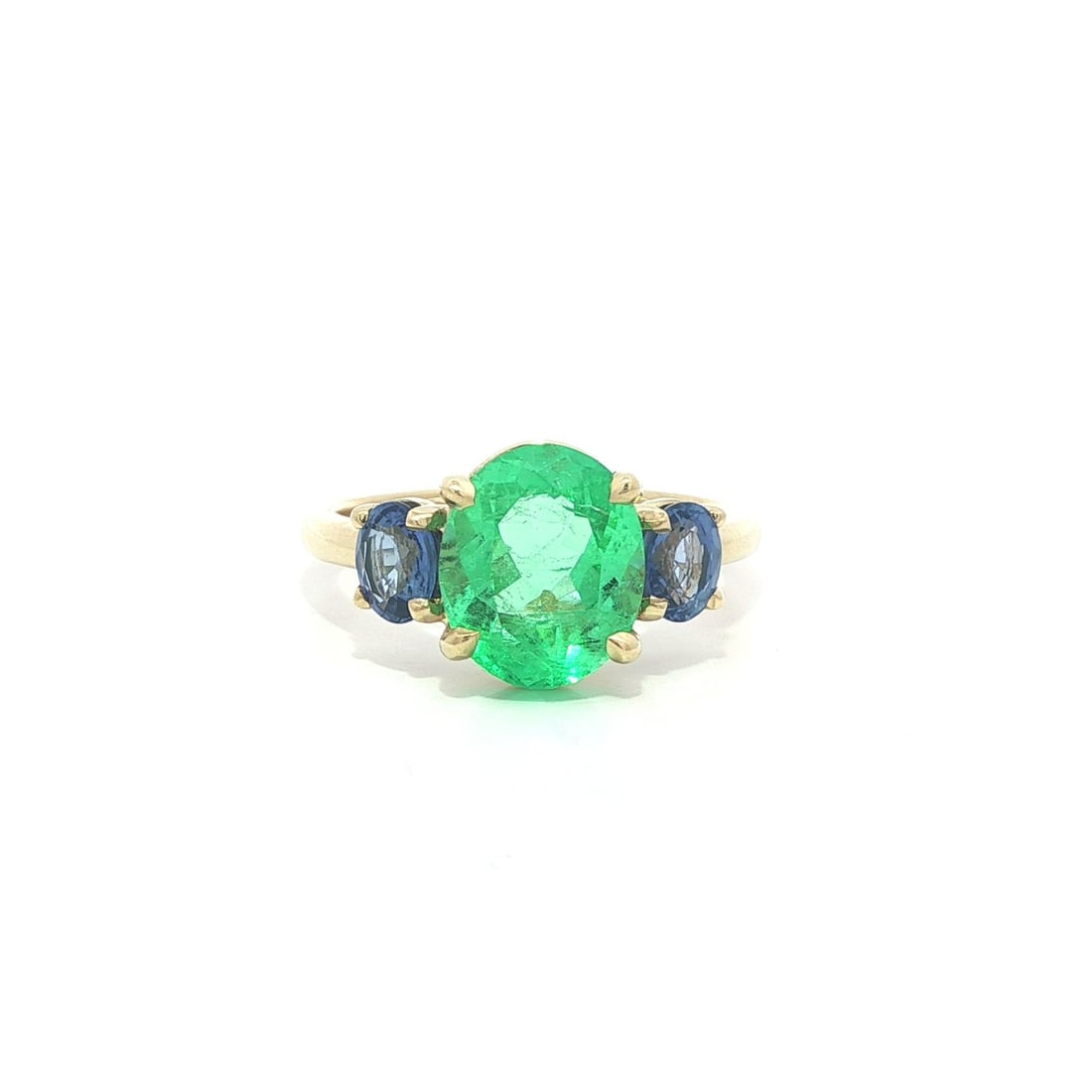 GIA Certified Colombian Emerald and Sapphire 3.66ctw Three Stone 18k Yellow Gold Ring: GIA Certified Colombian Emerald and Sapphire 3.66ctw Three Stone 18k Yellow Gold Ring This un-used custom ring features a natural Colombian emerald as the centerpiece, certified by GIA and weighing 2.