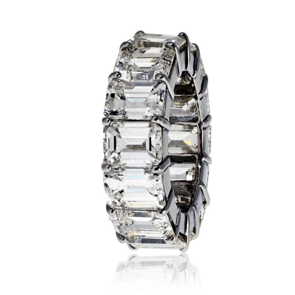 Platinum Eternity Ring with 18.00ct Emerald Cut Diamonds: Platinum Eternity Ring with 18.00ct Emerald Cut Diamonds This stunning platinum eternity ring showcases 14 emerald-cut diamonds with a total weight of 18.00 carats. Crafted with a timeless shared pron
