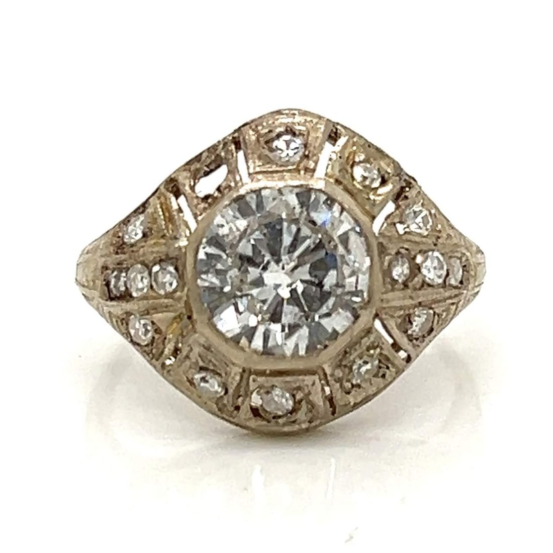 Art Deco Platinum Ring 1.50 Ct Diamond E-F I1 with 16 Diamonds: Art Deco Platinum Ring 1.50 Ct Diamond E-F I1 with 16 Diamonds This stunning Art Deco ring features a central diamond weighing approximately 1.50 carats, characterized by its E-F color and I1 clarity.