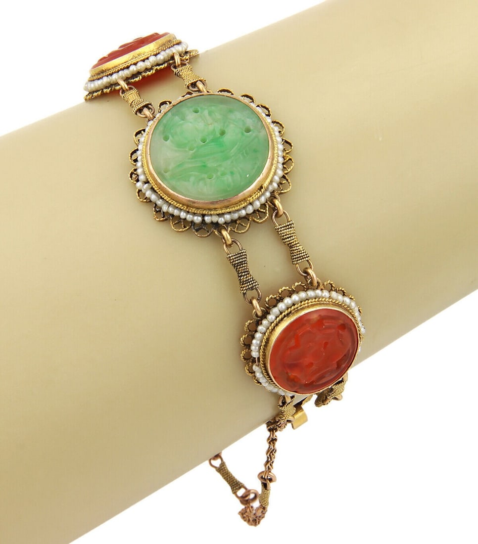 Vintage 14k Yellow Gold Jade Carnelian Seed Pearl Link Bracelet: Vintage 14k Yellow Gold Jade Carnelian Seed Pearl Link Bracelet This antique bracelet features intricately carved green jade panels, warm carnelian stones, and delicate seed pearl accents, all set in 