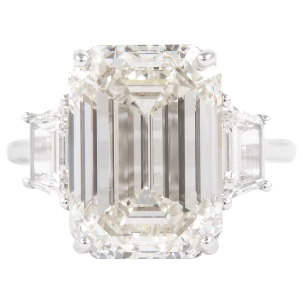 GIA Certified 10.06ct Emerald Cut Diamond Ring in 18k White Gold: GIA Certified 10.06ct Emerald Cut Diamond Ring in 18k White Gold This exquisite three-stone engagement ring features a stunning GIA certified 10.06ct emerald cut diamond, renowned for its M color grad