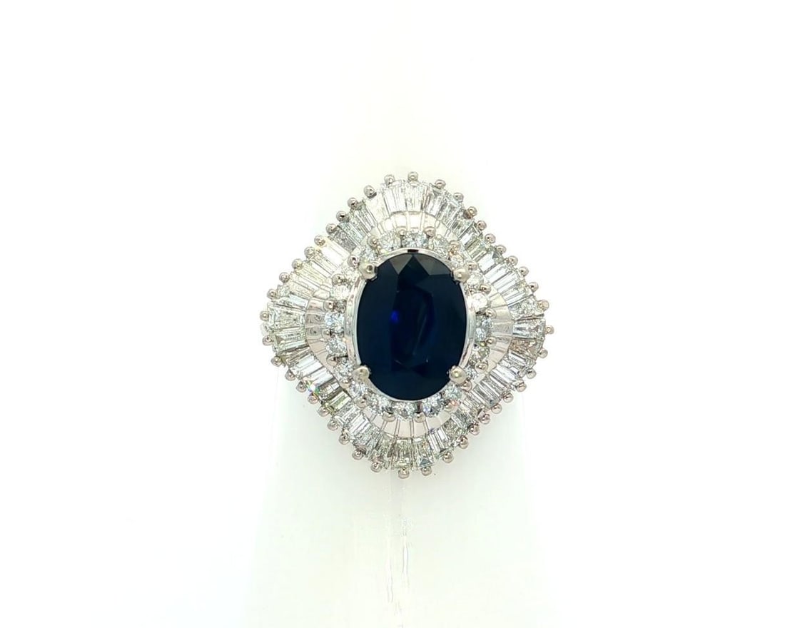 Platinum 3.21ctw Ballerina Ring with Deep Blue Sapphire and Diamond Accents: Platinum 3.21ctw Ballerina Ring with Deep Blue Sapphire and Diamond Accents Make a bold statement with this exquisite Platinum Ballerina Ring, featuring a stunning deep blue oval sapphire at its cente