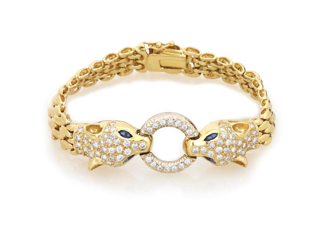 Luxury 18k Yellow Gold Diamond Sapphire Panther Bracelet: Luxury 18k Yellow Gold Diamond Sapphire Panther Bracelet This stunning double panther head bracelet features a unique door knocker design, expertly crafted from 18k yellow gold with a high polished fi