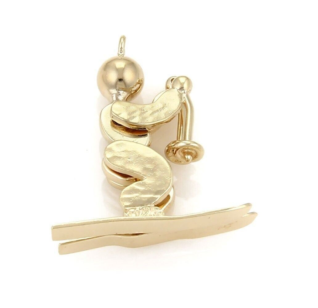 Vintage 14k Yellow Gold Articulated Skier Charm Pendant: Vintage 14k Yellow Gold Articulated Skier Charm Pendant This vintage skier animated figure charm pendant is crafted from 14k yellow gold and features an articulated skier motif, offering playful movem