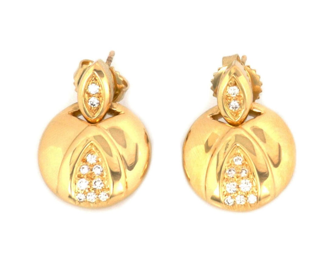 Movado 18k Yellow Gold Diamond Dangle Earrings: Movado 18k Yellow Gold Diamond Dangle Earrings These authentic Movado dangle earrings are crafted from solid 18k yellow gold and feature a sculptural drop design. Each earring is accented with sparkli