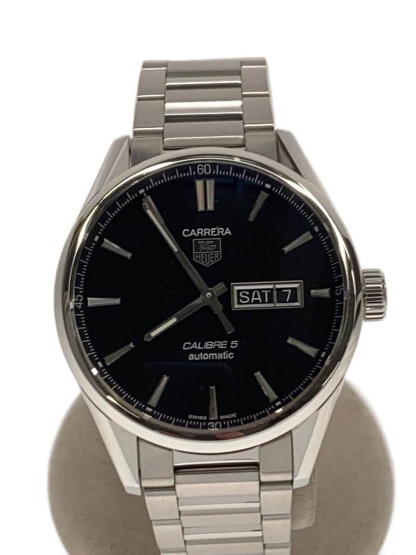 TAG Heuer stainless steel Carrera Calibre 5 day-date wristwatch: TAG Heuer stainless steel Carrera Calibre 5 day-date wristwatch This TAG Heuer Carrera Calibre 5 Day-Date men's wristwatch features a silver stainless steel case and band. Designed for durability, it 