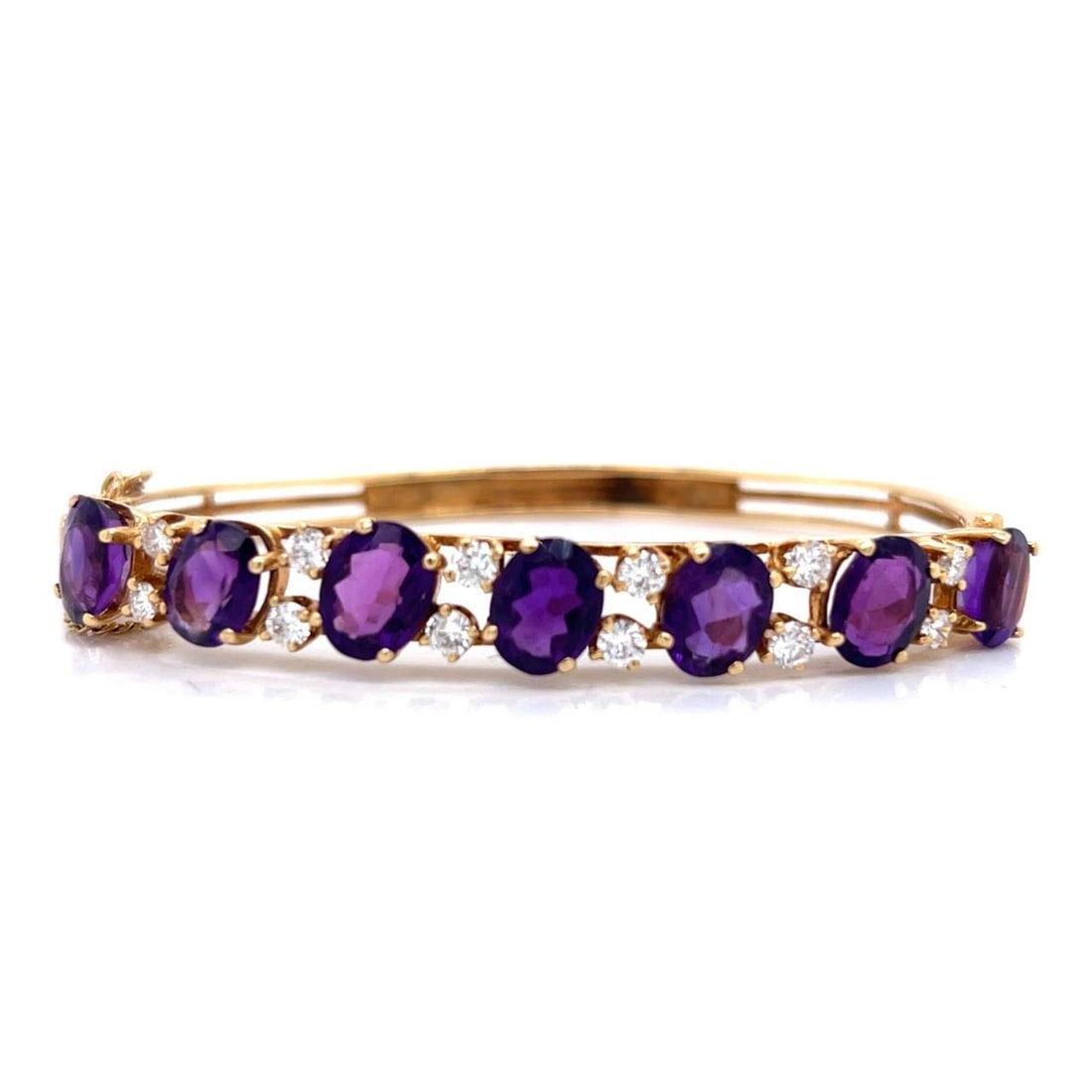 14K Yellow Gold Bangle Bracelet with Amethyst and Diamond: 14K Yellow Gold Bangle Bracelet with Amethyst and Diamond This exquisite 14K Yellow Gold Bangle Bracelet features a stunning arrangement of 7 vibrant Amethysts and 12 sparkling Diamonds. Weighing 20.3