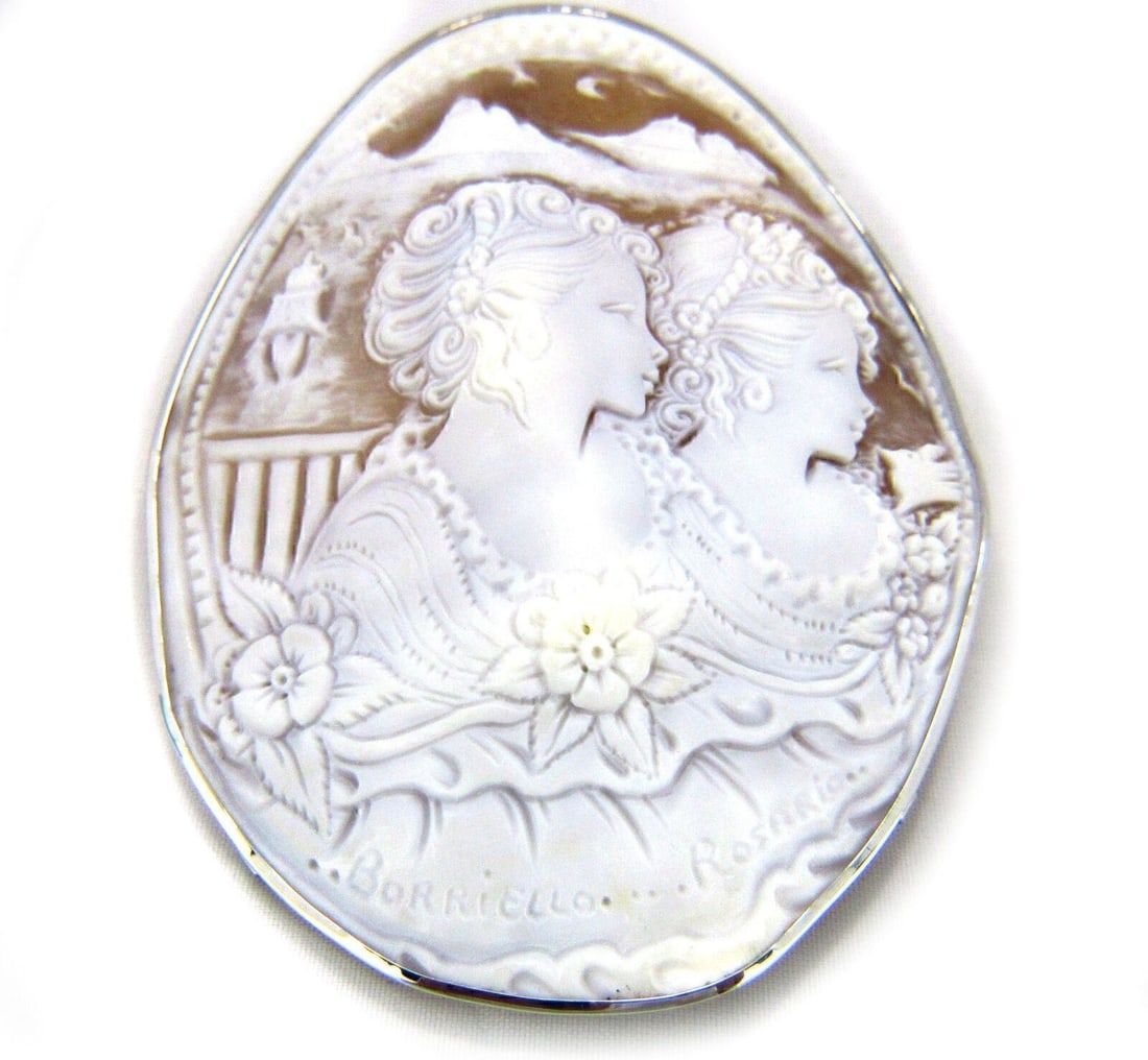 18k White Gold Oval Shell Cameo Brooch Pendant Two Women: 18k White Gold Oval Shell Cameo Brooch Pendant Two Women This vintage brooch pendant is crafted in 18k white gold and showcases an extra large, oval-shaped shell cameo intricately carved with the imag
