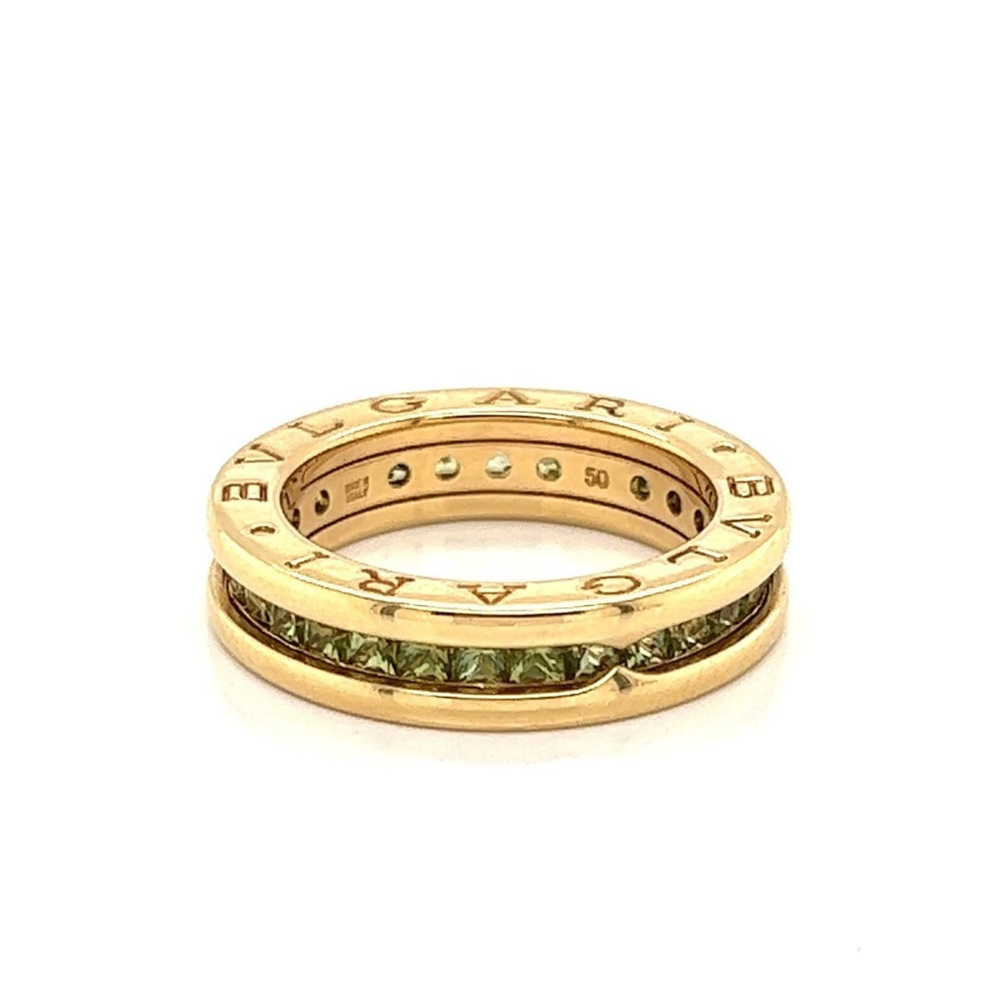 Bvlgari B.zero1 peridot 18k yellow gold ring size 5: Bvlgari B.zero1 peridot 18k yellow gold ring size 5 This authentic Bvlgari B.zero1 Eternity Band Ring features a continuous row of vibrant green peridot gemstones set in solid 18k yellow gold. Showcas