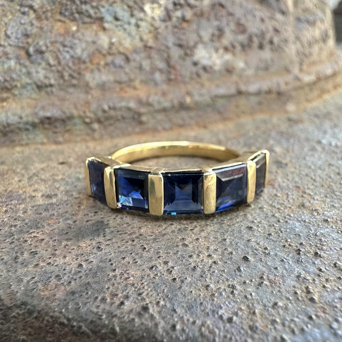 18k Yellow Gold Sapphire 5 Stone Band Ring Size 6.5: 18k Yellow Gold Sapphire 5 Stone Band Ring Size 6.5 This elegant band ring features five natural, square step-cut dark blue sapphires with a total carat weight of 2.63, channel bar set in solid 18k ye