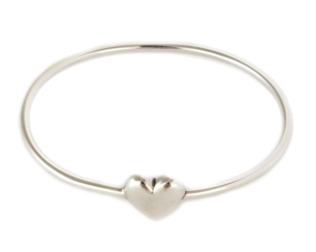 Tiffany & Co. Heart Wire Sterling Silver Bangle Bracelet: Tiffany & Co. Heart Wire Sterling Silver Bangle Bracelet This authentic vintage Tiffany & Co. heart wire bangle bracelet is crafted from sterling silver. It features a minimalist wire design with a po