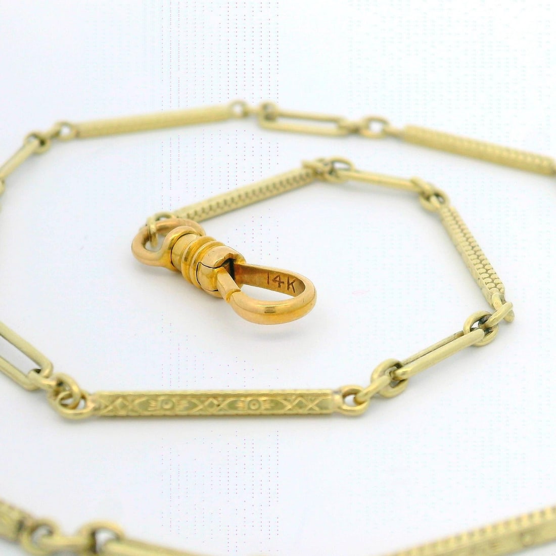 Art Deco Era 12k-14k Yellow Gold Elongated Link Pocket Watch Chain 13.75 Inch: Art Deco Era 12k-14k Yellow Gold Elongated Link Pocket Watch Chain 13.75 Inch This antique Art Deco pocket watch chain is crafted from 12k-14k yellow gold and features intricate engraved and hand-etch