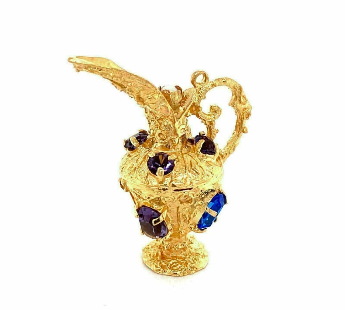 14k Yellow Gold Water Jug Charm Pendant with Amethyst Sapphire: 14k Yellow Gold Water Jug Charm Pendant with Amethyst Sapphire This vintage water jug charm pendant is crafted from solid 14k yellow gold and showcases a sculptural, whimsical silhouette. It is accent