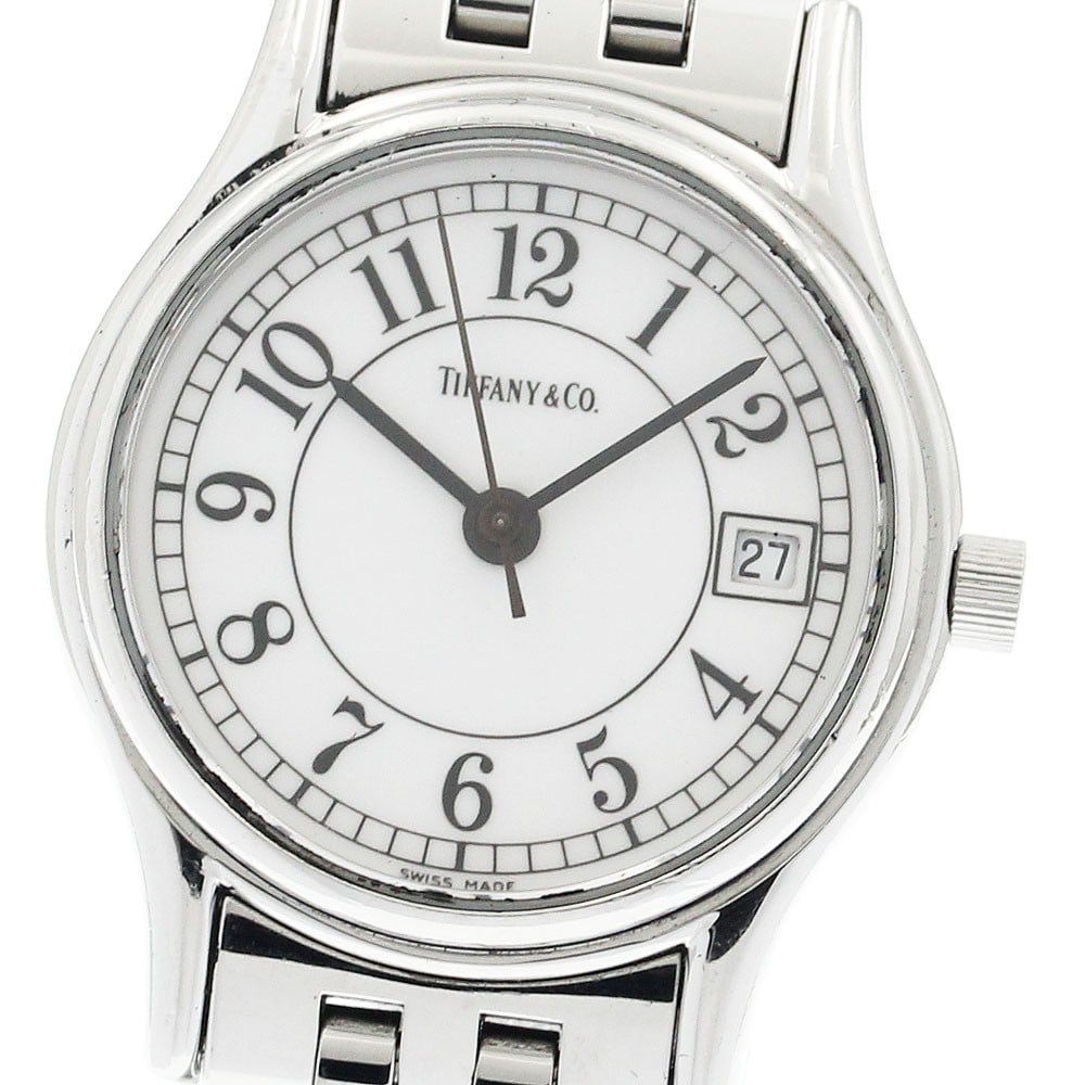 Tiffany Classic quartz date ladies stainless steel wristwatch: Tiffany Classic quartz date ladies stainless steel wristwatch This Tiffany & Co. Classic Date Quartz women's wristwatch features a stainless steel case and bracelet with a white dial. The watch is equ