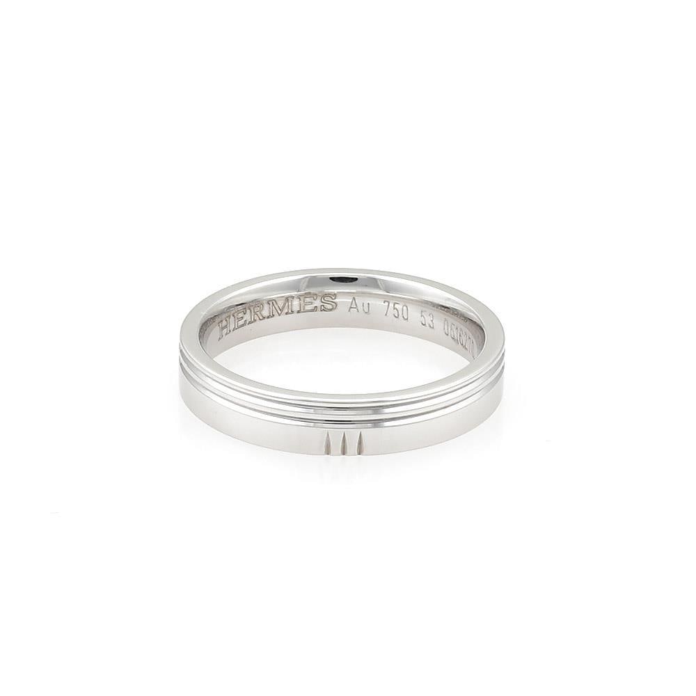 Hermes 18k White Gold 4mm Double Grooved Band Ring Size 53 US 6.5: Hermes 18k White Gold 4mm Double Grooved Band Ring Size 53 US 6.5 This elegant band ring from Hermes is crafted from 18k white gold and features a polished finish. The 4mm wide band showcases a fine d