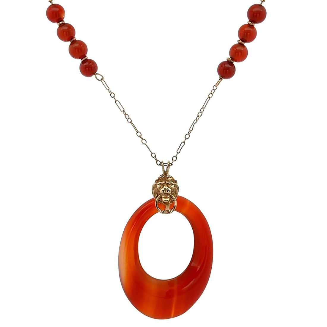 Vintage 13-14k Yellow Gold Agate Lion's Head Pendant Necklace: Vintage 13-14k Yellow Gold Agate Lion's Head Pendant Necklace This exquisite vintage necklace features a stunning Lion's Head door knocker pendant adorned with natural orange Carnelian or Agate stones