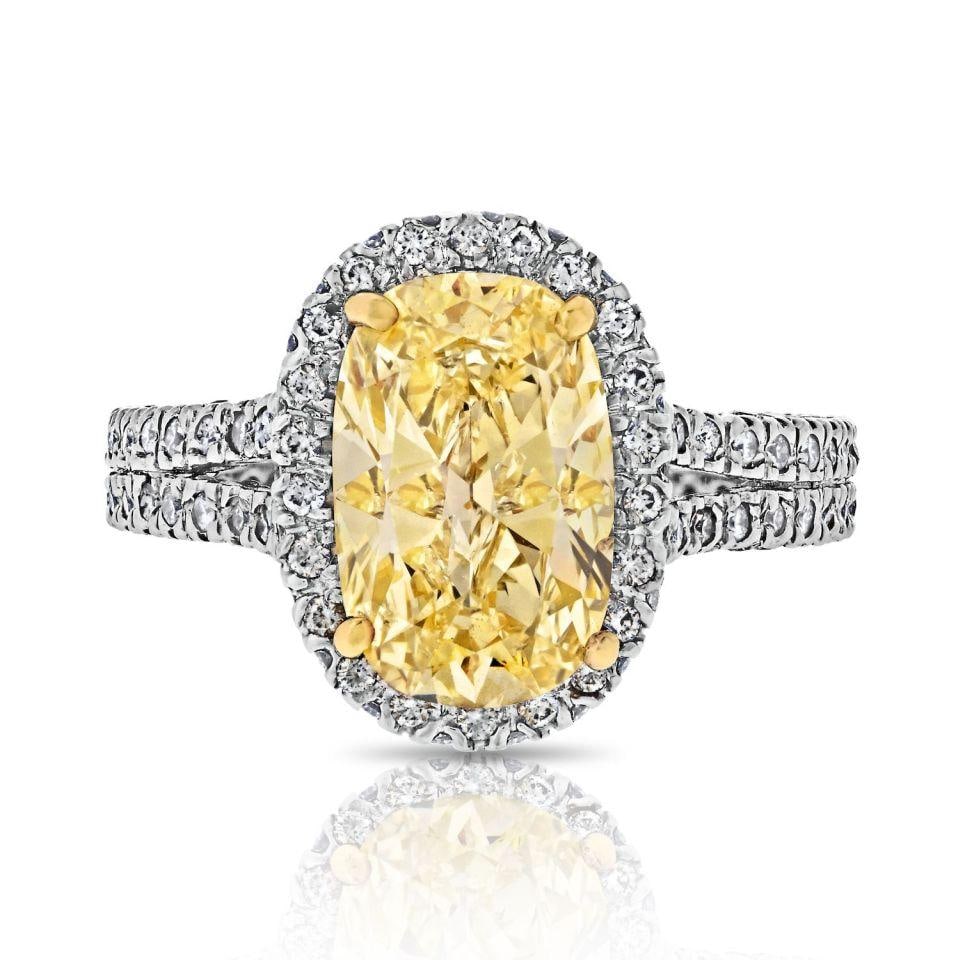 2.2 Carat Fancy Yellow Oval Diamond Ring in Platinum and 18K Gold: 2.2 Carat Fancy Yellow Oval Diamond Ring in Platinum and 18K Gold This exquisite ring features a stunning 2.2-carat oval diamond set in a captivating design. Crafted with a combination of platinum and