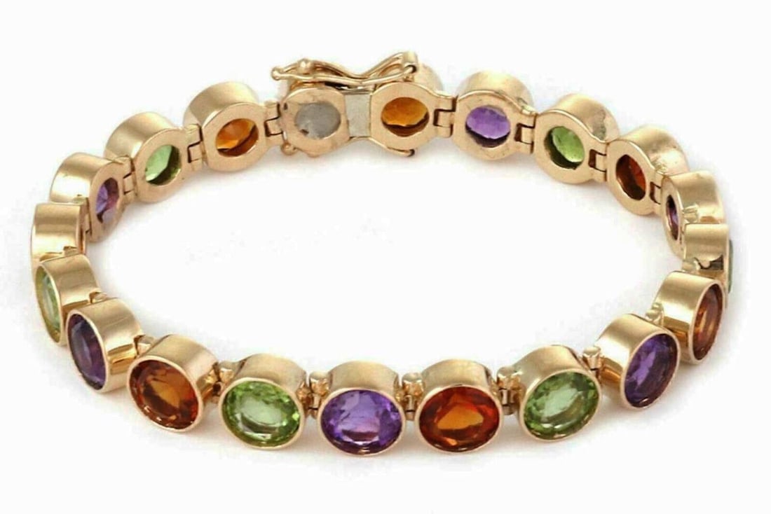 14k Yellow Gold Tennis Bracelet with Citrine Amethyst Peridot: 14k Yellow Gold Tennis Bracelet with Citrine Amethyst Peridot This vintage tennis bracelet is crafted from solid 14k yellow gold and features an elegant link design adorned with bezel-set citrine, ame