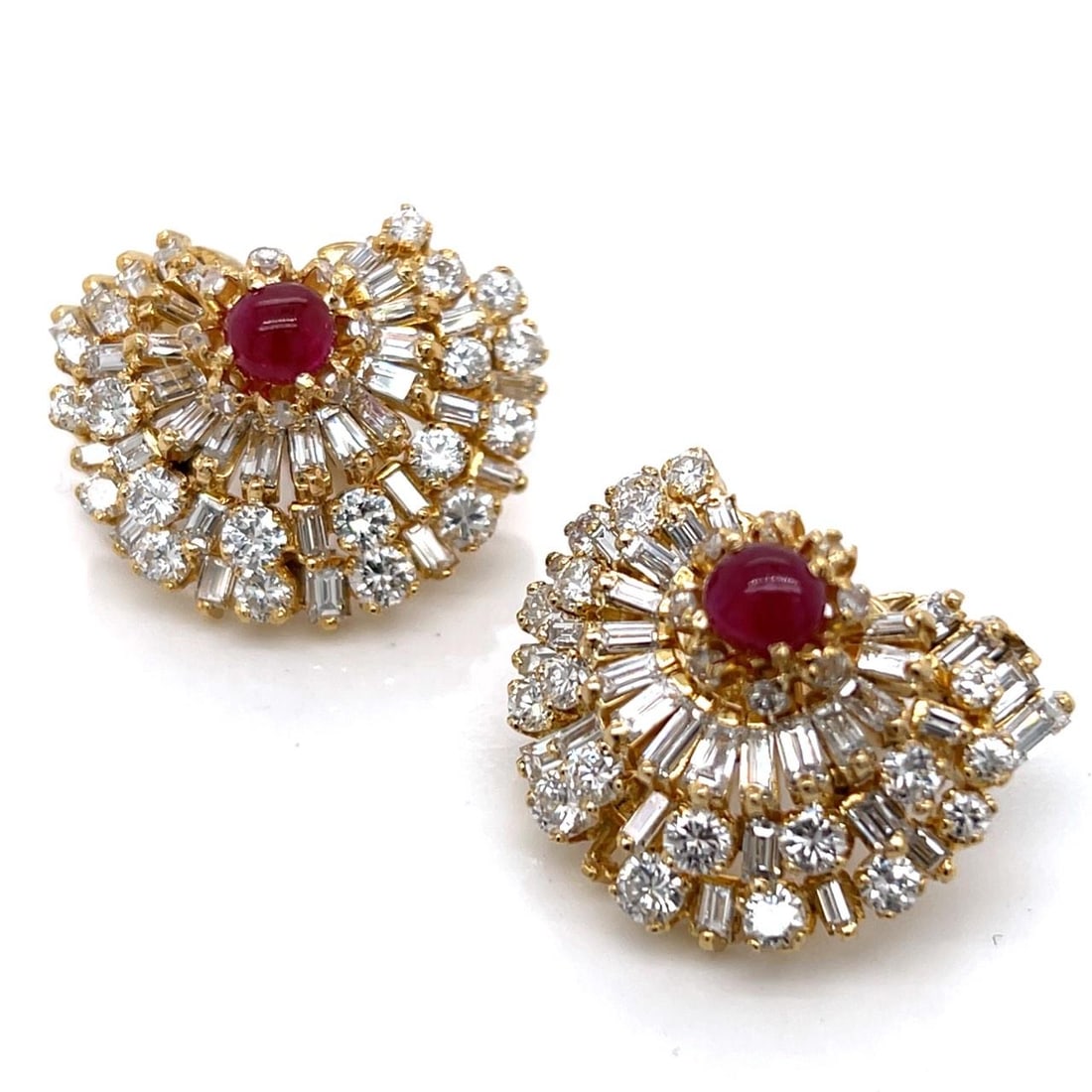 Earrings in Platinum and 18K Gold Featuring Rubies and Diamonds: Earrings in Platinum and 18K Gold Featuring Rubies and Diamonds These earrings are crafted from platinum and 18K yellow gold, featuring two rubies with an approximate total weight of 1.00 carat. The e