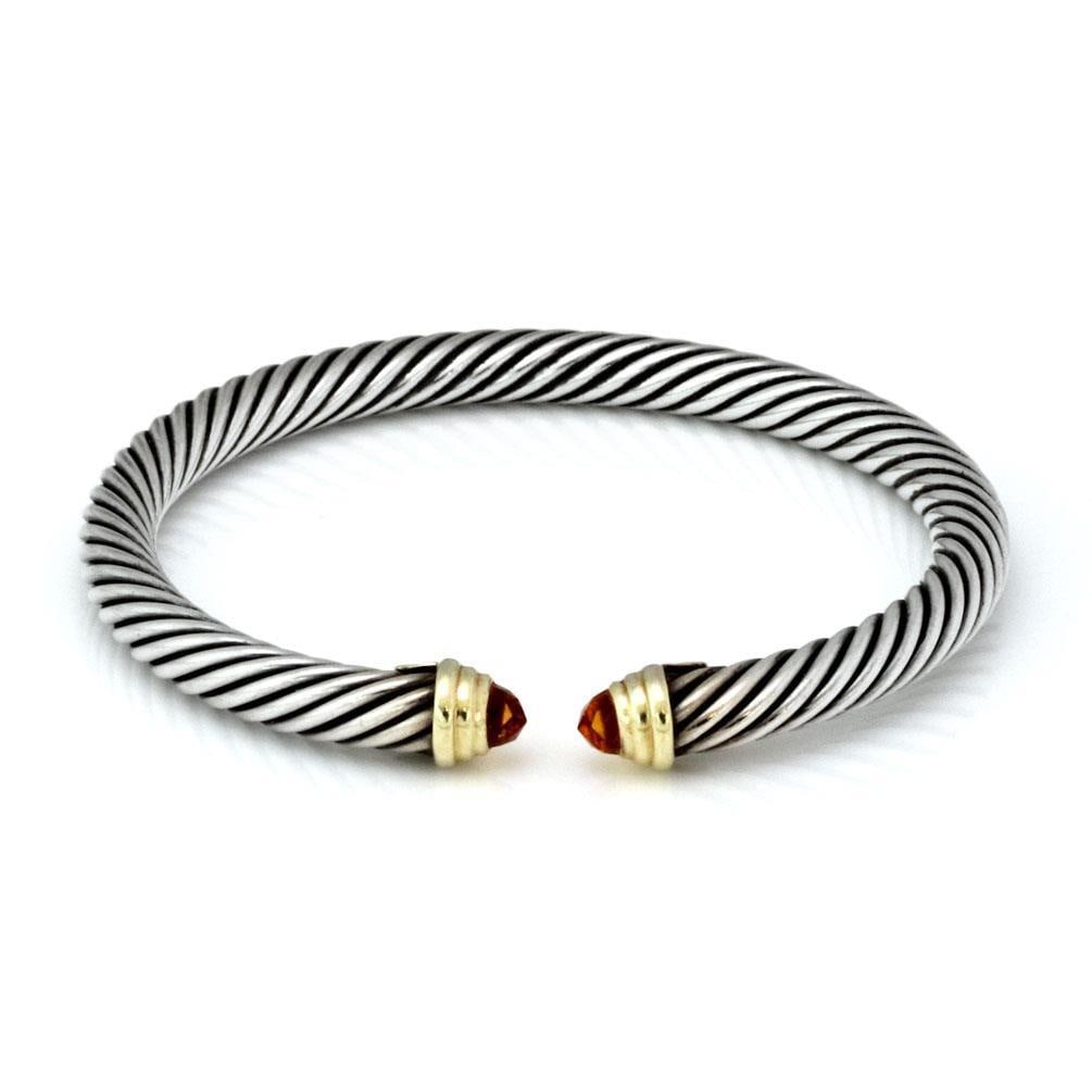 David Yurman 925 Sterling Silver Cuff Bracelet 14k Gold & Gems Cable Design: David Yurman 925 Sterling Silver Cuff Bracelet 14k Gold & Gems Cable Design Elevate your accessory collection with this stunning cuff bracelet by David Yurman. Crafted from luxurious sterling silver a