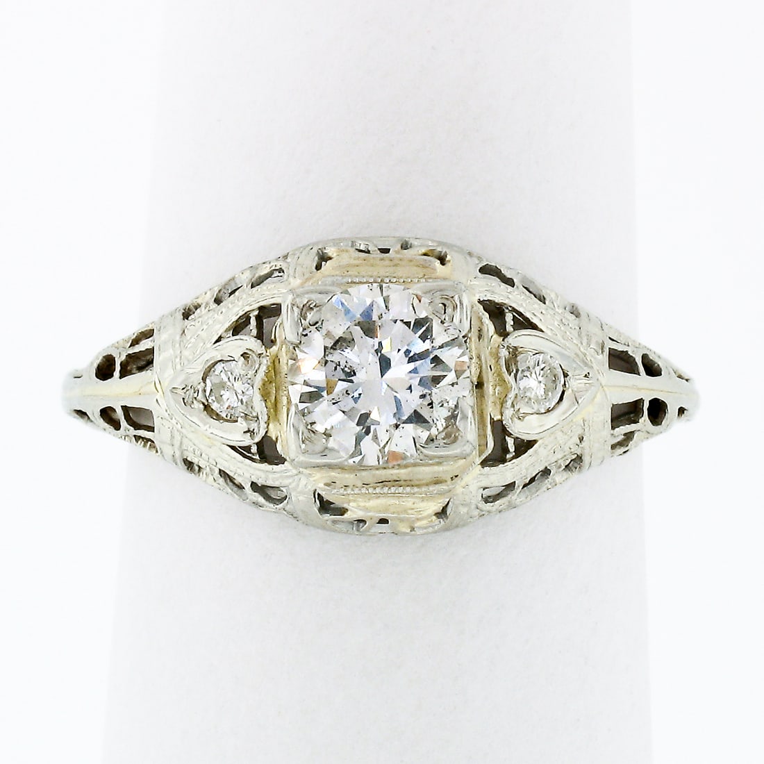 Vintage 18k White Gold Filigree Diamond Solitaire Engagement Ring: Vintage 18k White Gold Filigree Diamond Solitaire Engagement Ring This exquisite vintage engagement or promise ring is crafted in solid 18k white gold, showcasing a stunning solitaire design. The cent