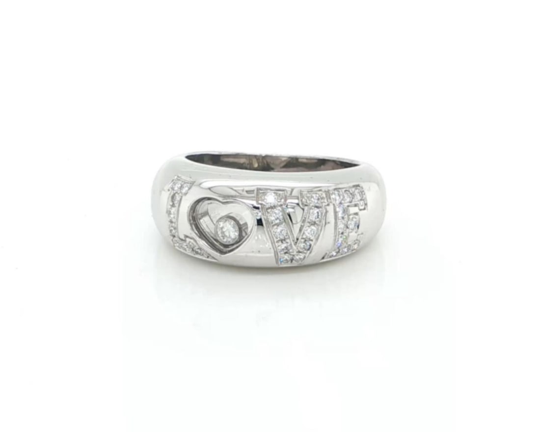 Chopard Happy Diamonds LOVE floating diamond ring 18k white gold size 4 certificate: Chopard Happy Diamonds LOVE floating diamond ring 18k white gold size 4 certificate This Chopard Happy Diamonds LOVE Dome Band Ring is expertly crafted from 18k white gold and features the brand's ico